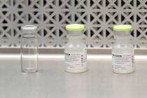 This March 16, 2020, file photo shows vials used by pharmacists to prepare syringes used on the ...