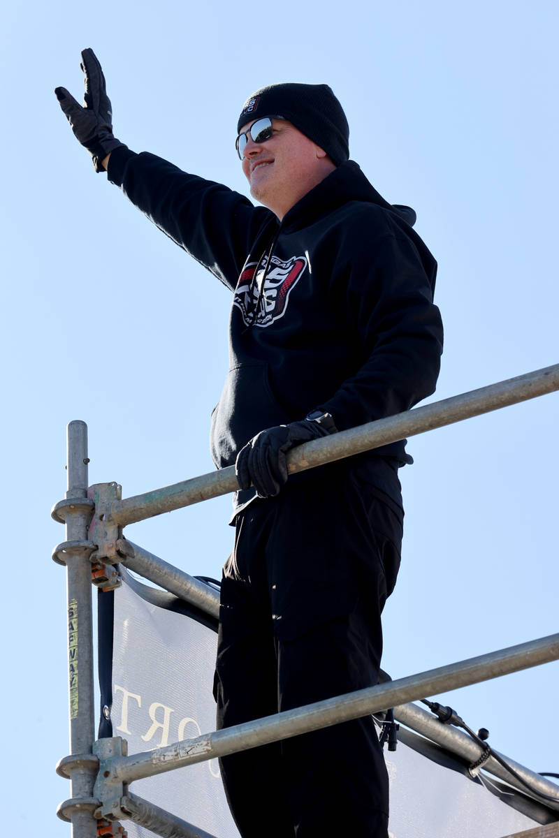Chet Buchanan of KLUC-FM waves at passing cars atop a 30-foot scaffolding during his toy drive ...