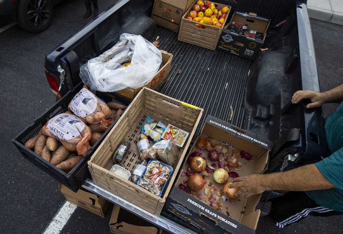 People in need get donated food from Amber Stevenson at a shopping center in Las Vegas on Wedne ...