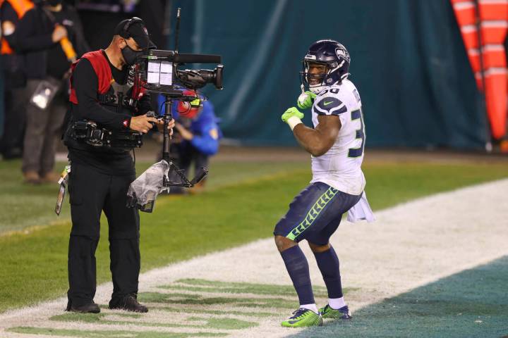 Seattle Seahawks' Carlos Hyde (30) celebrates in front of an ESPN Monday Night Football camera ...