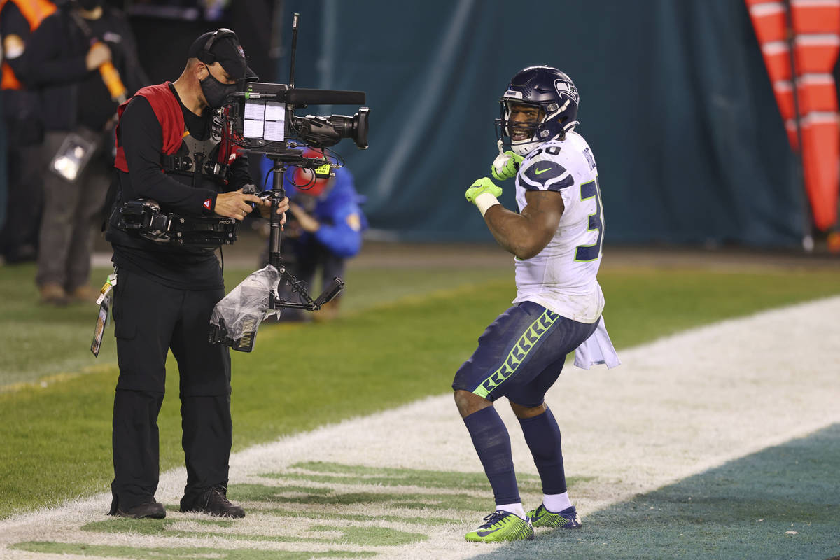 Seattle Seahawks' Carlos Hyde (30) celebrates in front of an ESPN Monday Night Football camera ...
