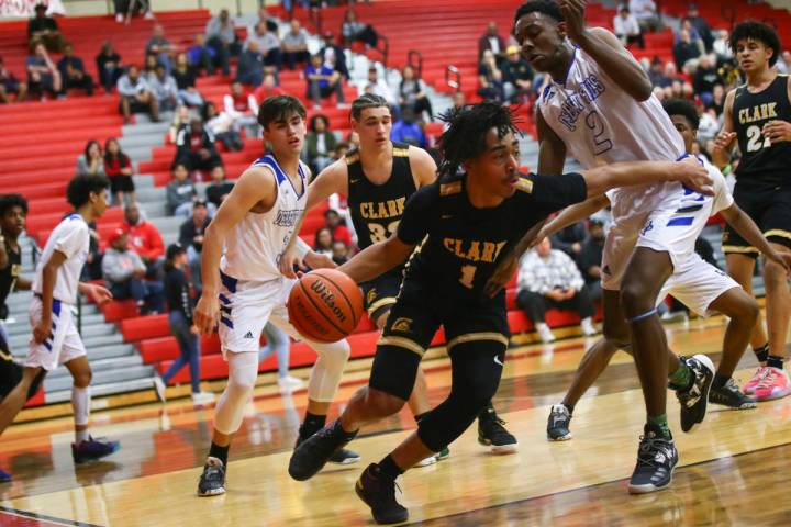 Clark's Frankie Collins (1) moves the ball around Desert Pines' Dayshawn Wiley (2) during the f ...