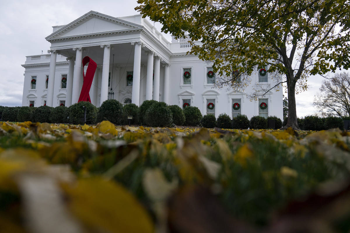 A ribbon hangs on the White House for World AIDS Day 2020, Tuesday, Dec. 1, 2020, in Washington ...