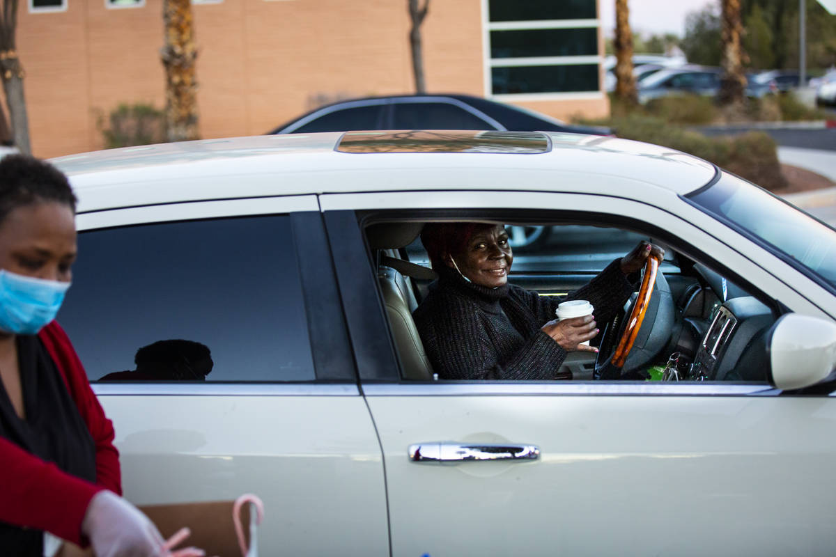 Ronny Flowers, of Las Vegas, drives by after getting a warm cup of hot chocolate during a chari ...