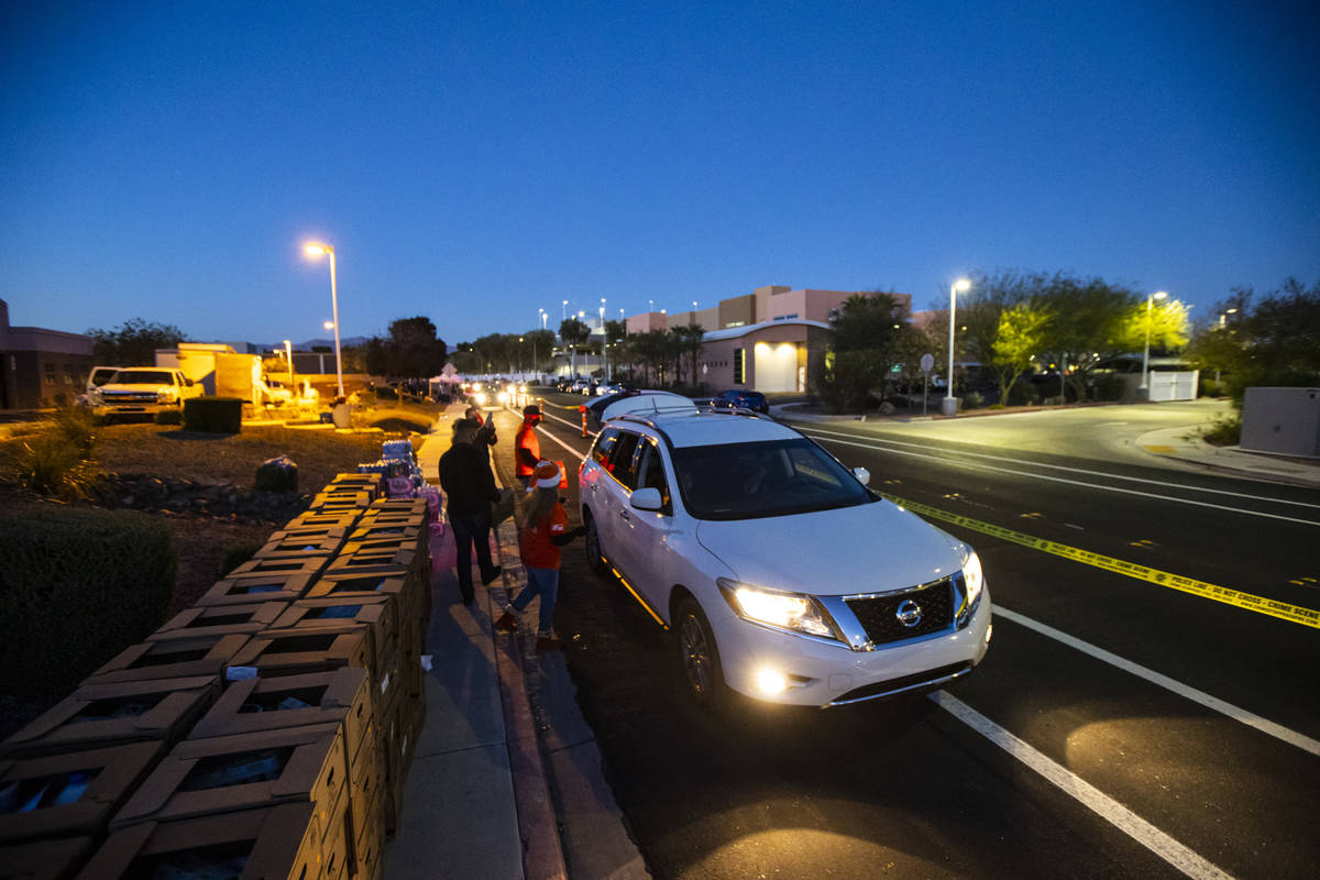 Volunteers with Home Depot deliver cases of water along with meals, holiday decorating kits, ha ...