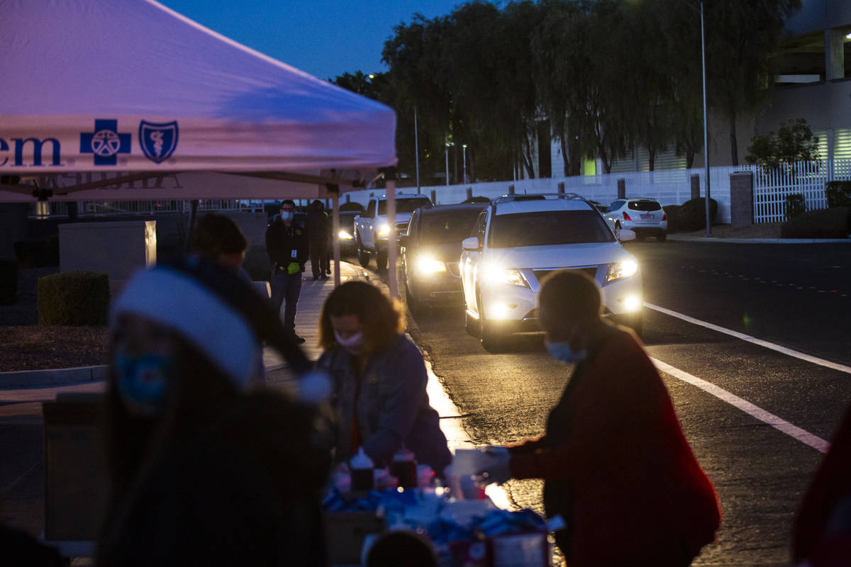 Families line up for a charity drive-thru event at Metro's Bolden Area Command substation in La ...