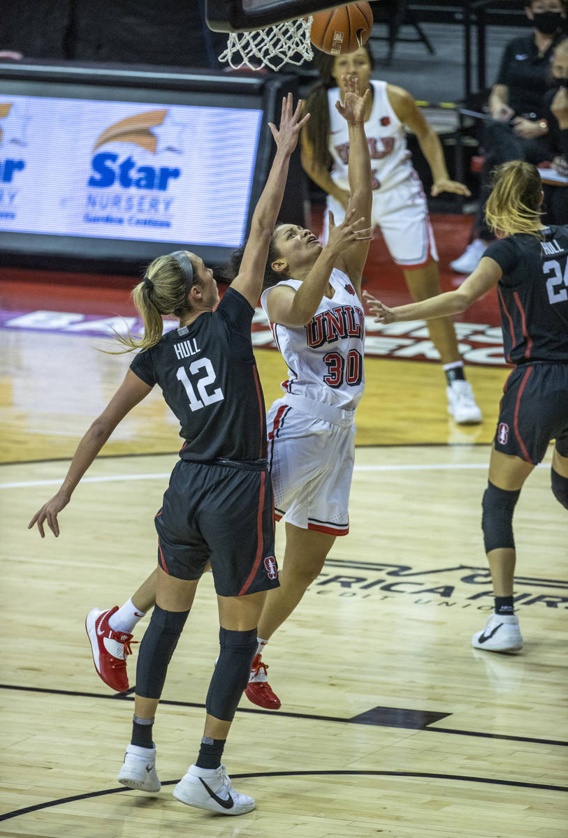 UNLV Lady Rebels guard Nia Johnson (30) lays in a basket past Stanford Cardinal guard Lexie Hul ...