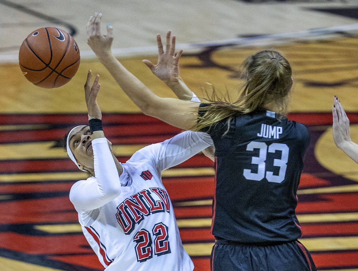UNLV Lady Rebels forward Tianna Carter (22, left) has the ball poked away by Stanford Cardinal ...