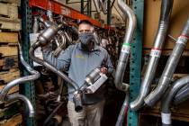 Chad Sims with the Supreme Automotive Warehouse holds one of the catalytic converters he has in ...