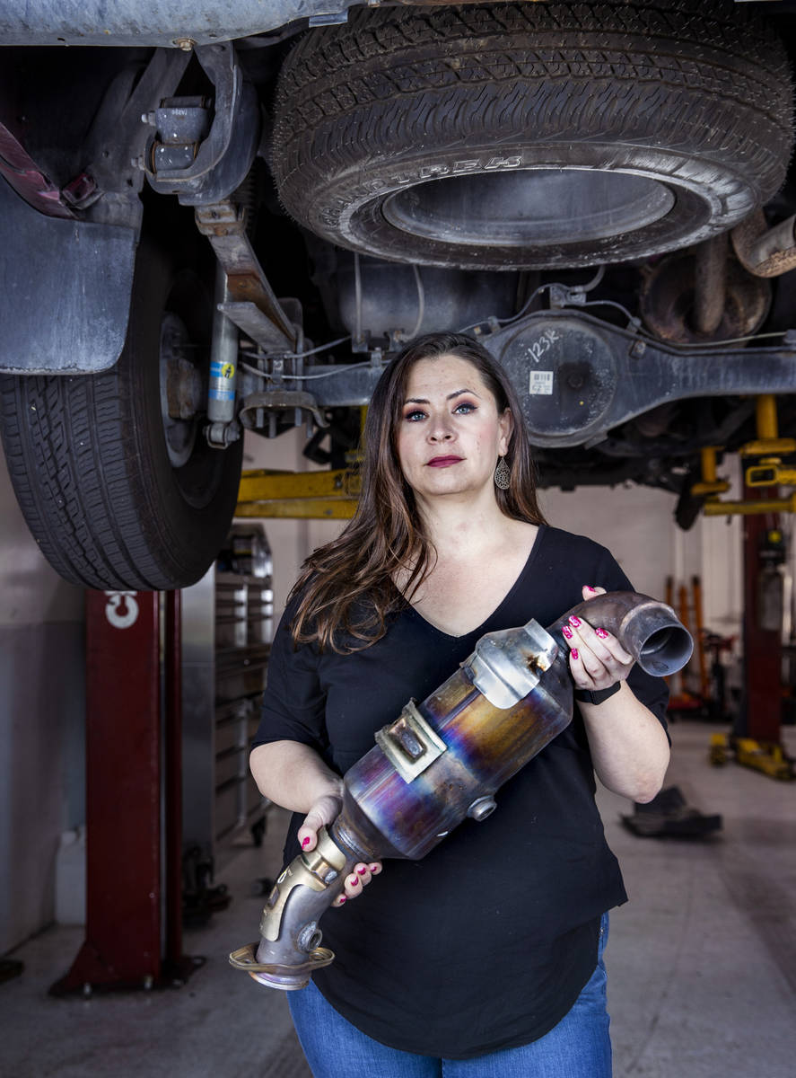 Danielle Vila, co-owner of Red Rock Repair, holds a recently removed catalytic converter at the ...