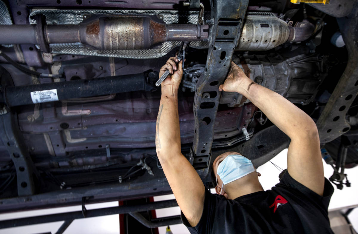 Mechanic Johnny Mejia with Red Rock Repair works beneath a car on Nov. 24, 2020. The shop's own ...