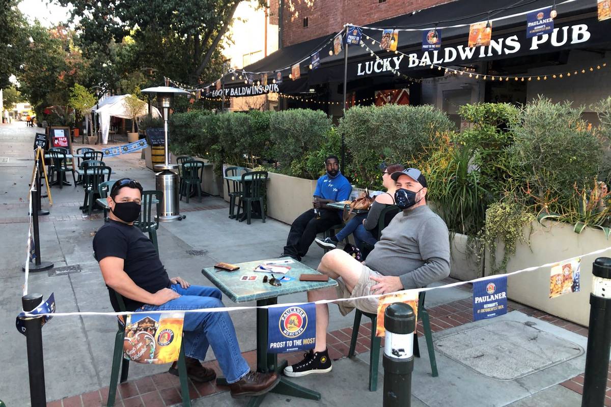 Anthony Angulo, left, and Jeff Koloski sit on the patio of Lucky Baldwin's pub on Monday, Nov. ...