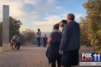 People take a look at a metal monolith found in San Luis Obispo, Calif., on Wednesday, Dec. 2, ...