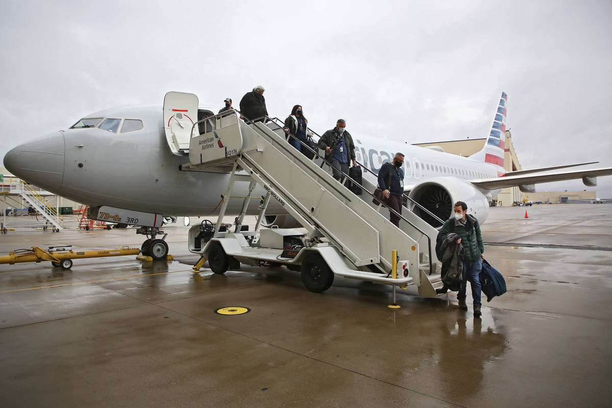 Journalists and American Airlines employees disembark a Boeing 737 Max at the American Airlines ...