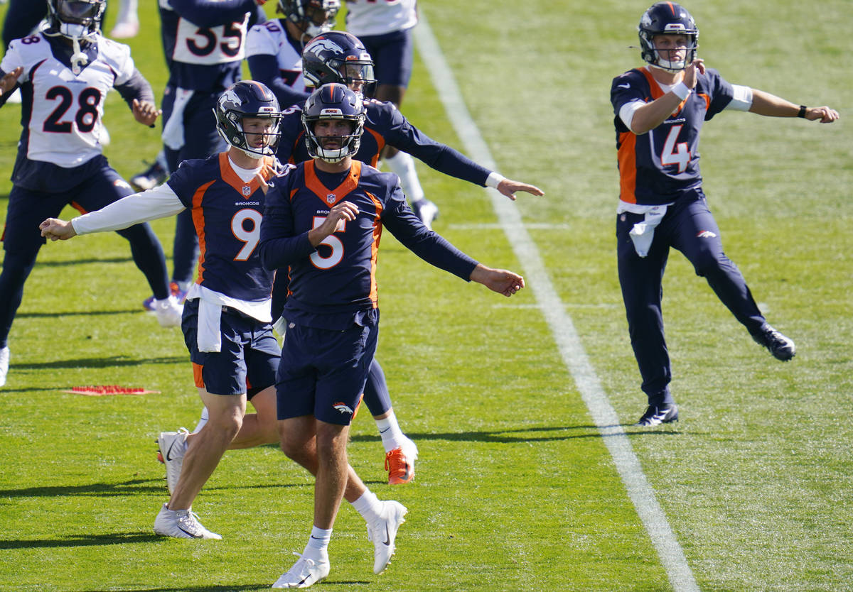 Denver Broncos quarterbacks Blake Bortles (5), Jeff Driskel (9), Drew Lock, obscured behind Bor ...