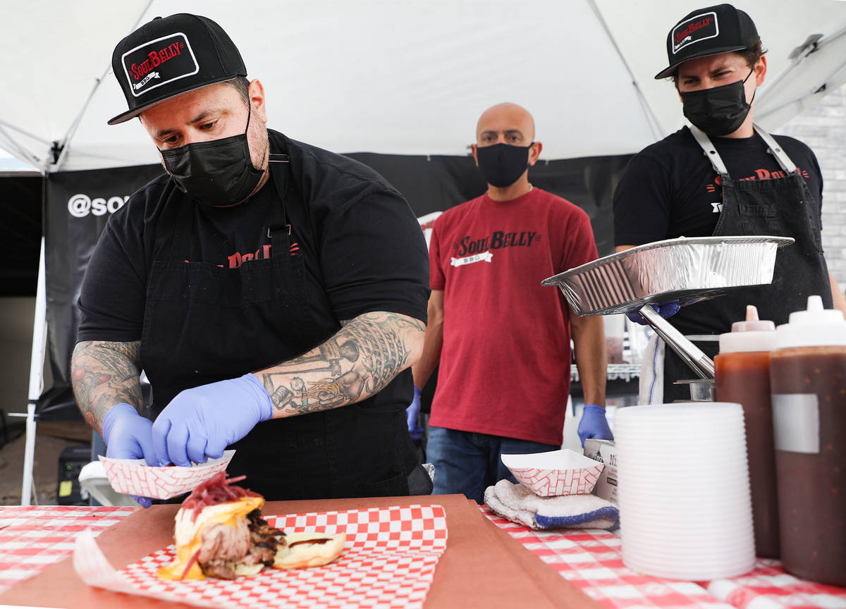 Chef and owner Bruce Kalman prepares the Belly of Soul sandwich at the SoulBelly BBQ pop-up in ...