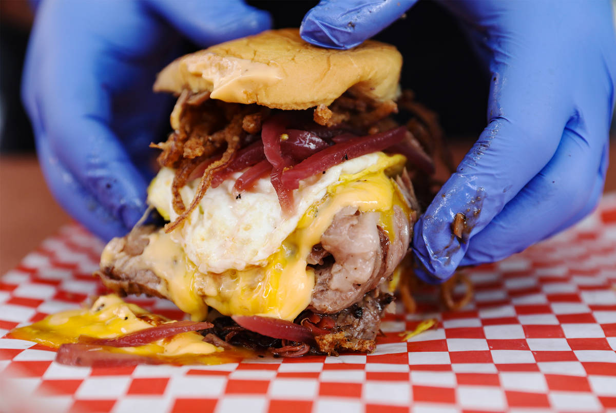 Chef and owner Bruce Kalman prepares the Belly of Soul sandwich made of brisket, homemade chees ...
