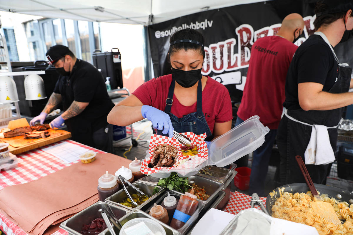 Sous-chef Myrhissa Bautista prepares a plate at the SoulBelly BBQ pop-up in the Arts District i ...