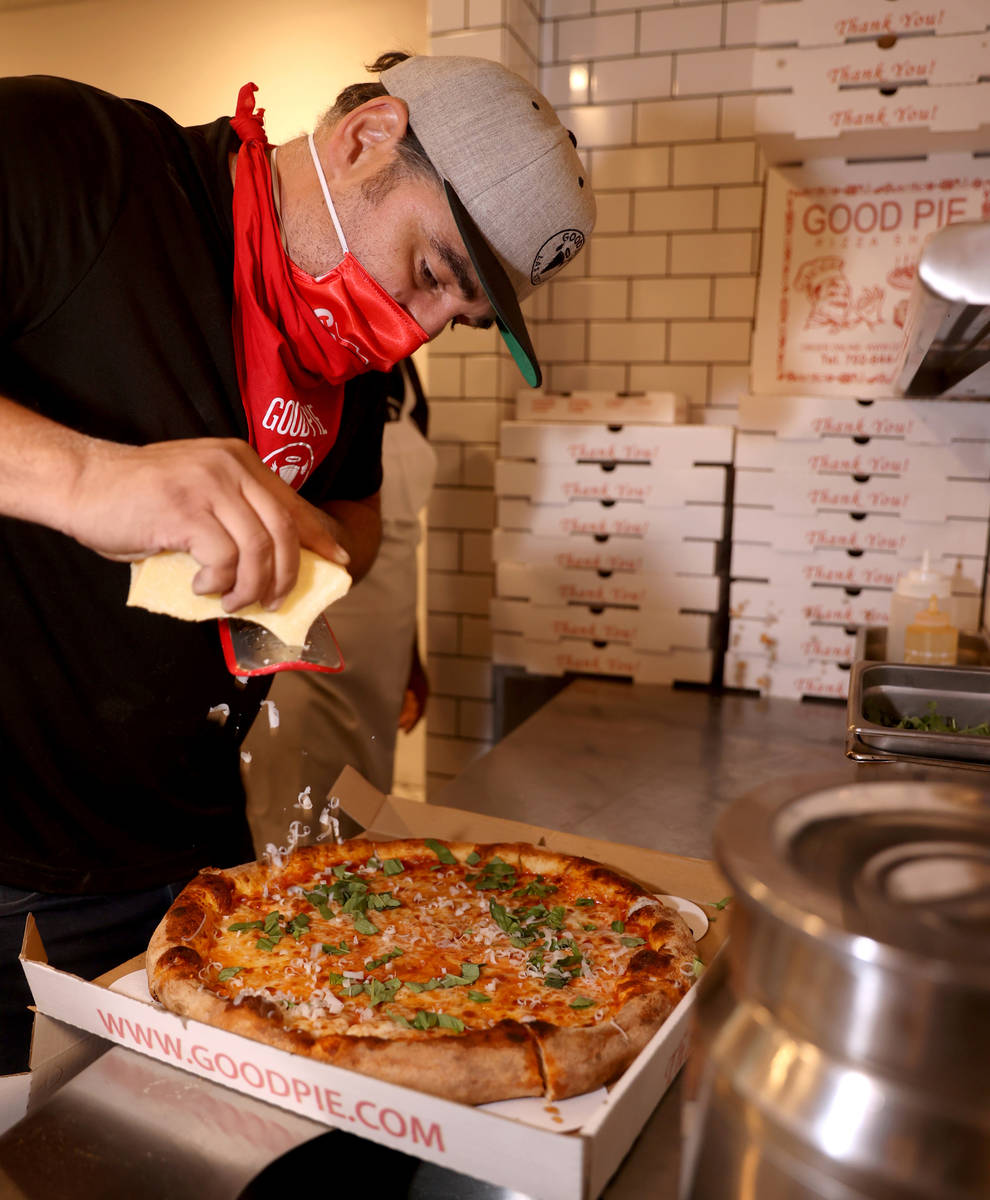 Good Pie owner Vincent Rotolo grates cheese on a pizza at his restaurant in the Arts District i ...