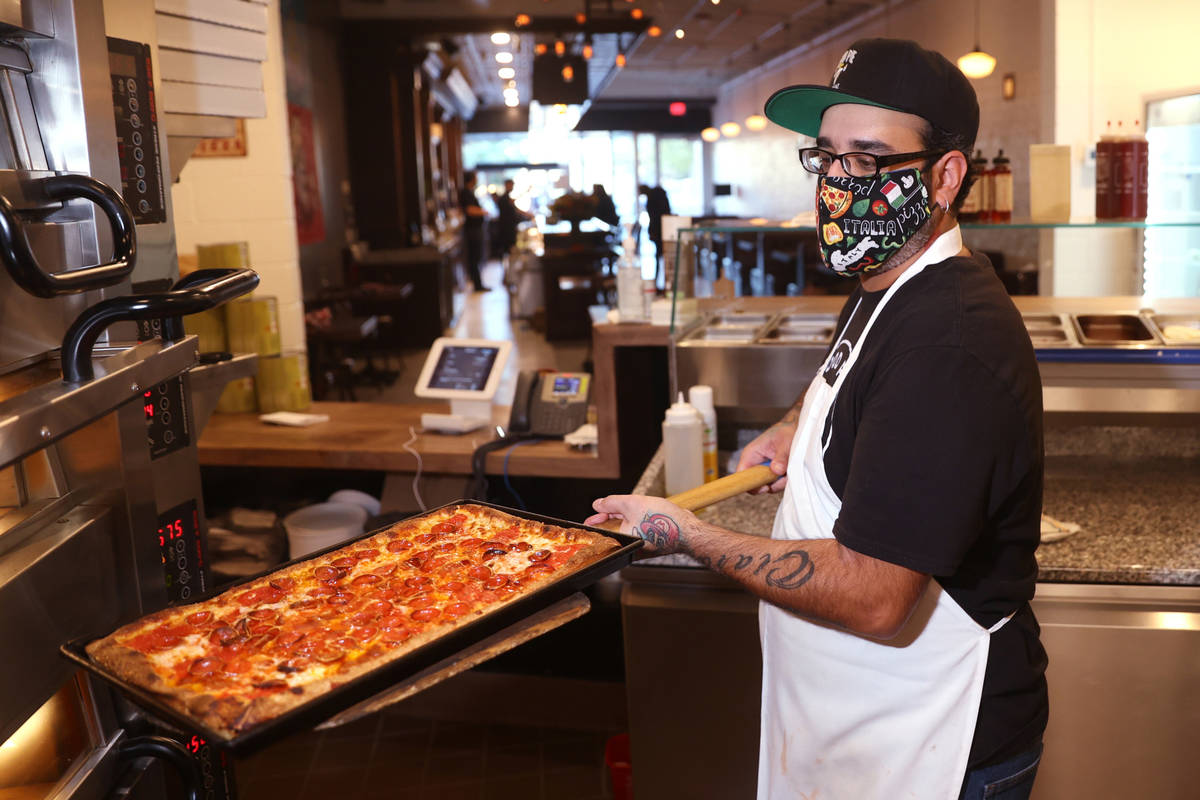 G. Perez prepares a pizza at Good Pie restaurant in the Arts District in downtown Las Vegas Wed ...