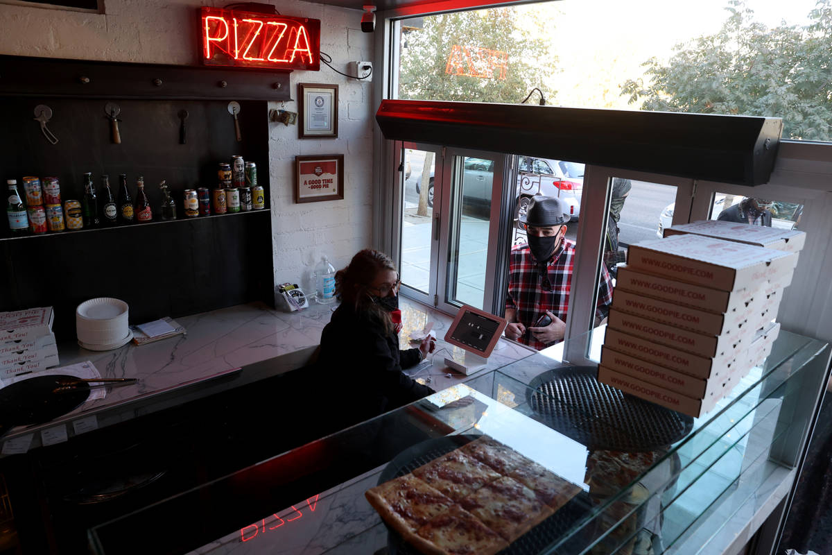 Lilian Martinez helps Jose Diaz of Las Vegas at the pizza slice window at Good Pie restaurant i ...