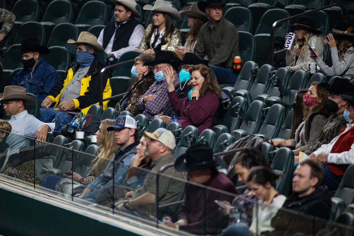 Crowd members watch PRCA contestants compete during the opening night of the National Finals Ro ...