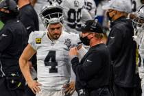 Las Vegas Raiders head coach Jon Gruden talks with quarterback Derek Carr (4) during the first ...