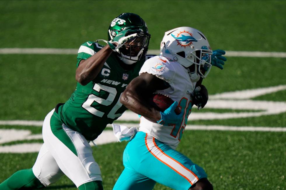 New York Jets' Marcus Maye, left, chases Miami Dolphins' Jakeem Grant during the first half of ...