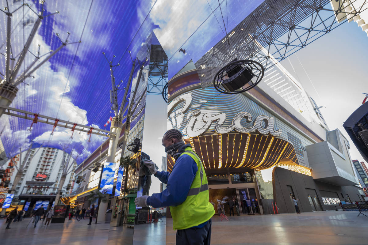 City of Las Vegas detail maintenance Michael Bradley cleans off fingerprints off of a 10-foot m ...