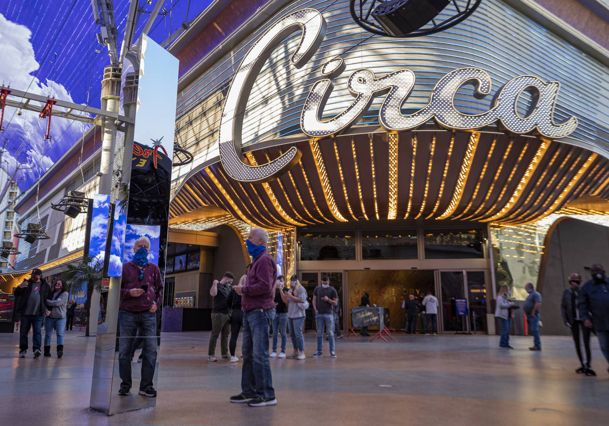 Dale Eagle, 74, looks at his reflection in a 10-foot monolith standing under the Fremont Street ...