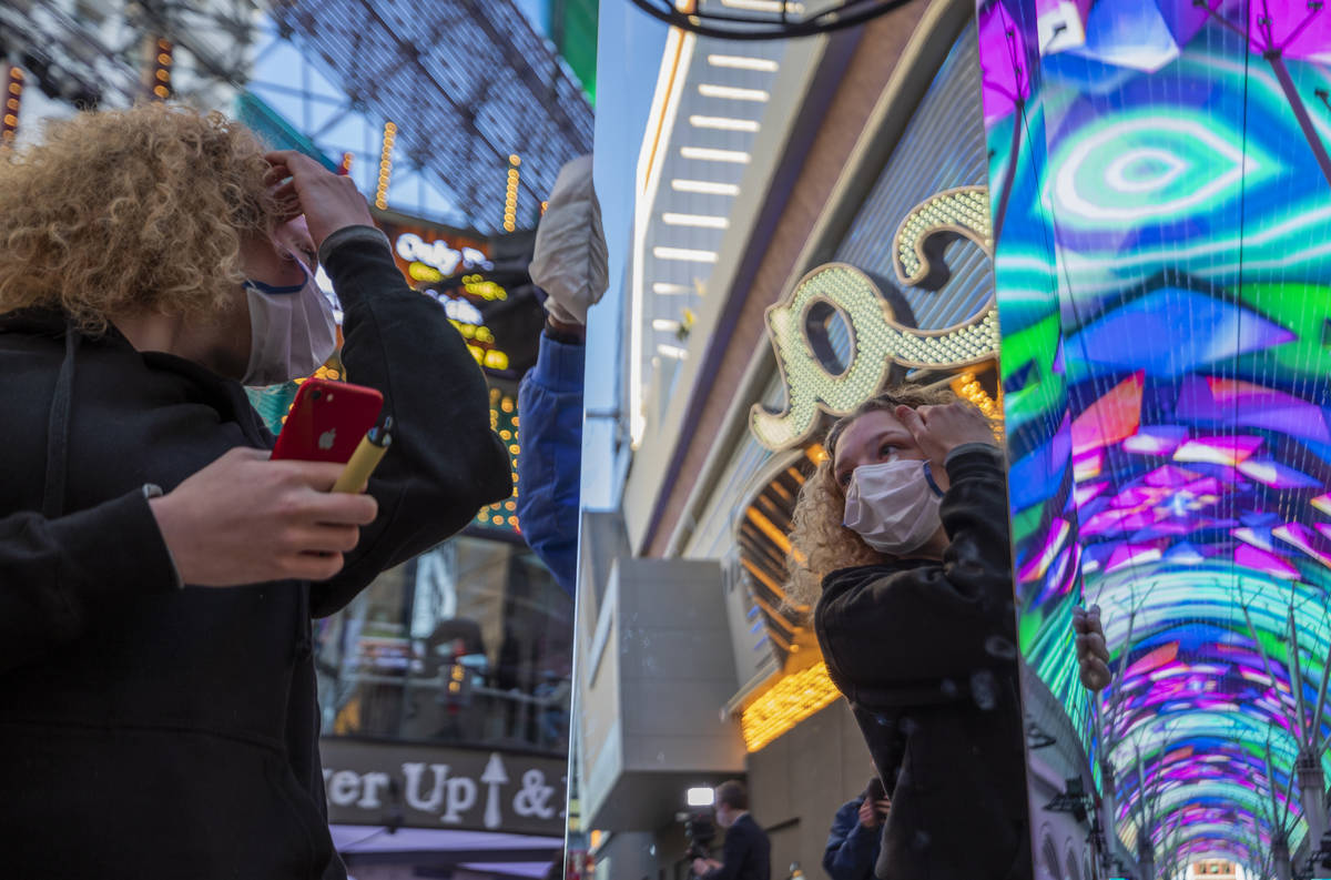 Frances Lovino, 18, of Las Vegas, looks at her reflection in a 10-foot monolith standing under ...