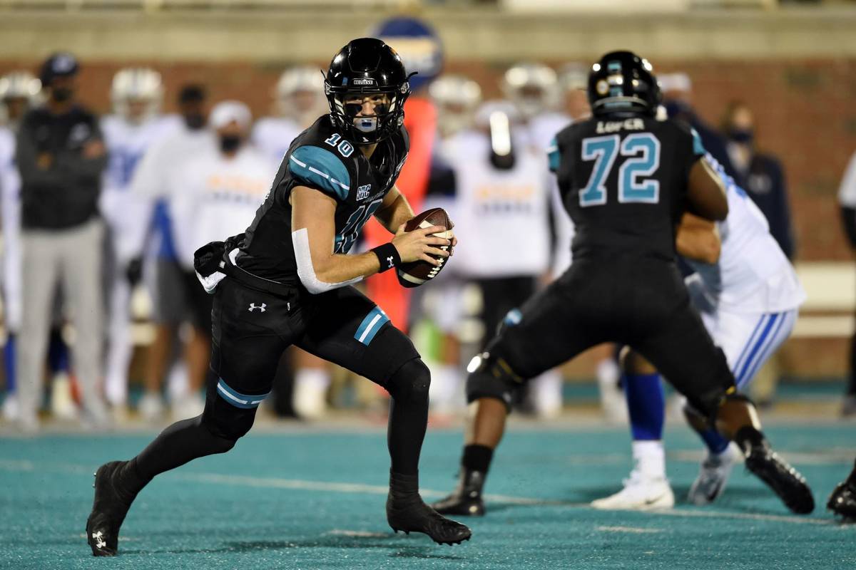 Coastal Carolina quarterback Grayson McCall, left, scrambles during the first half of an NCAA c ...