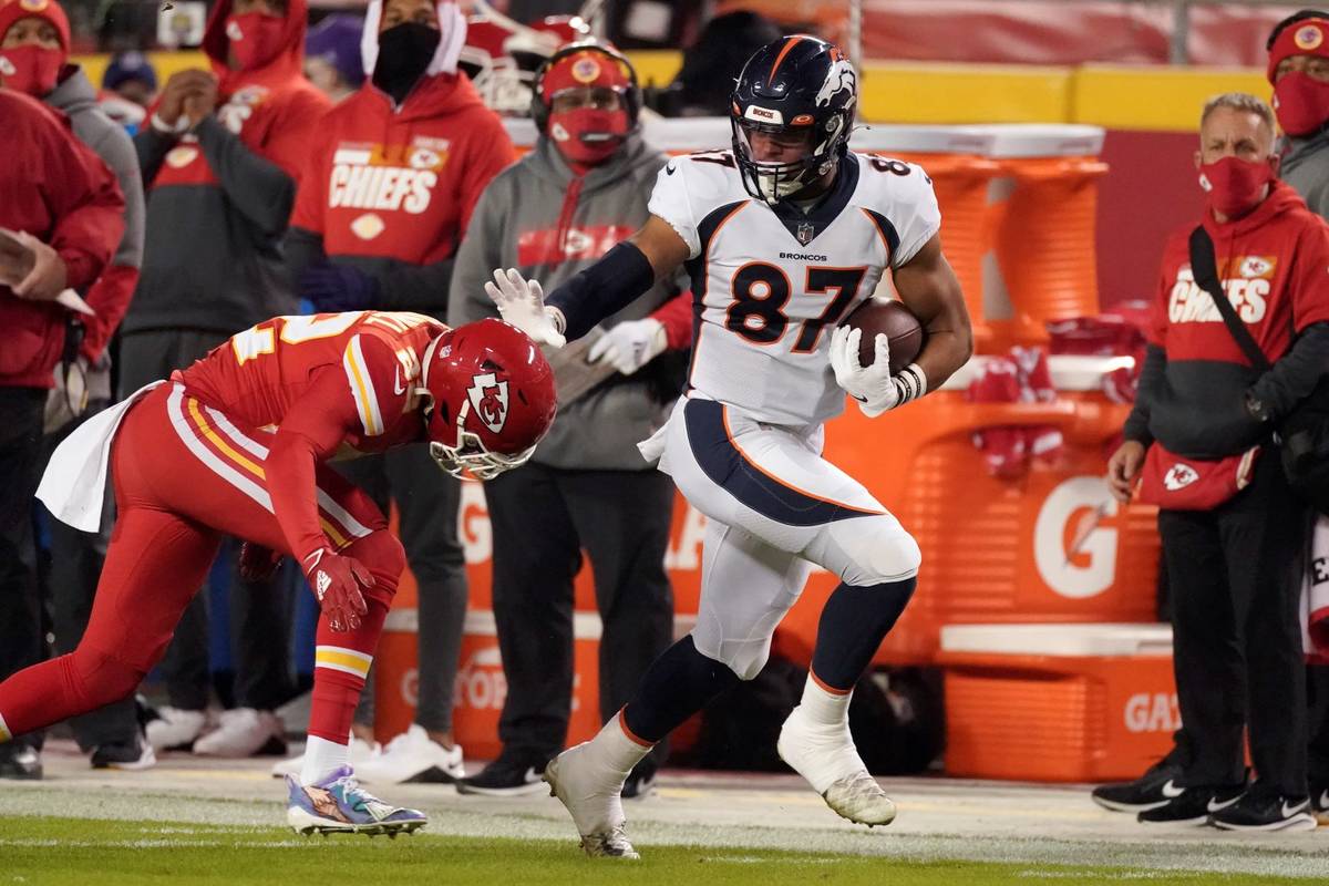 Denver Broncos tight end Noah Fant (87) tries to avoid Kansas City Chiefs free safety Juan Thor ...