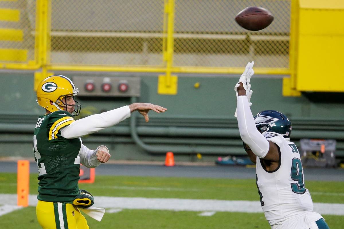 Green Bay Packers' Aaron Rodgers throws a pass during the first half of an NFL football game ag ...