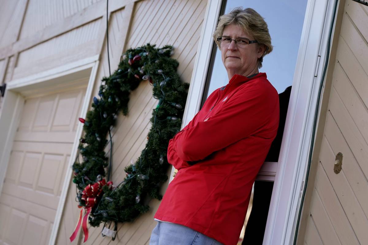 Keli Paaske stands outside her home in Olathe, Kan. Friday, Dec. 4, 2020. (AP Photo/Charlie Riedel)