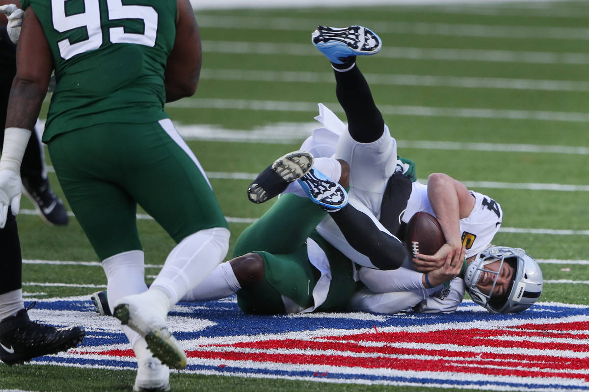 Las Vegas Raiders quarterback Derek Carr is sacked during the first half of an NFL football gam ...