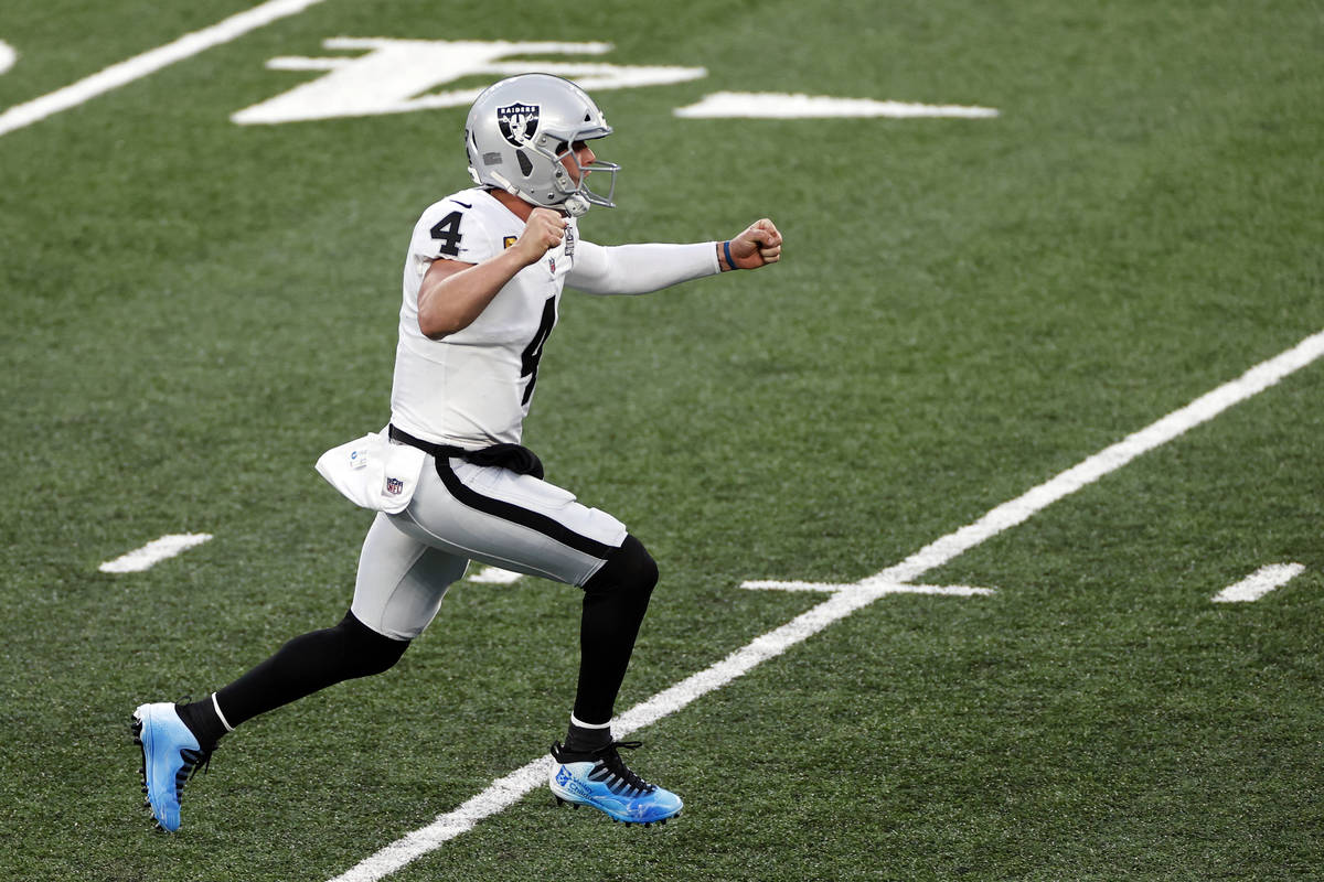 Las Vegas Raiders quarterback Derek Carr (4) reacts after throwing a game winning touchdown pas ...