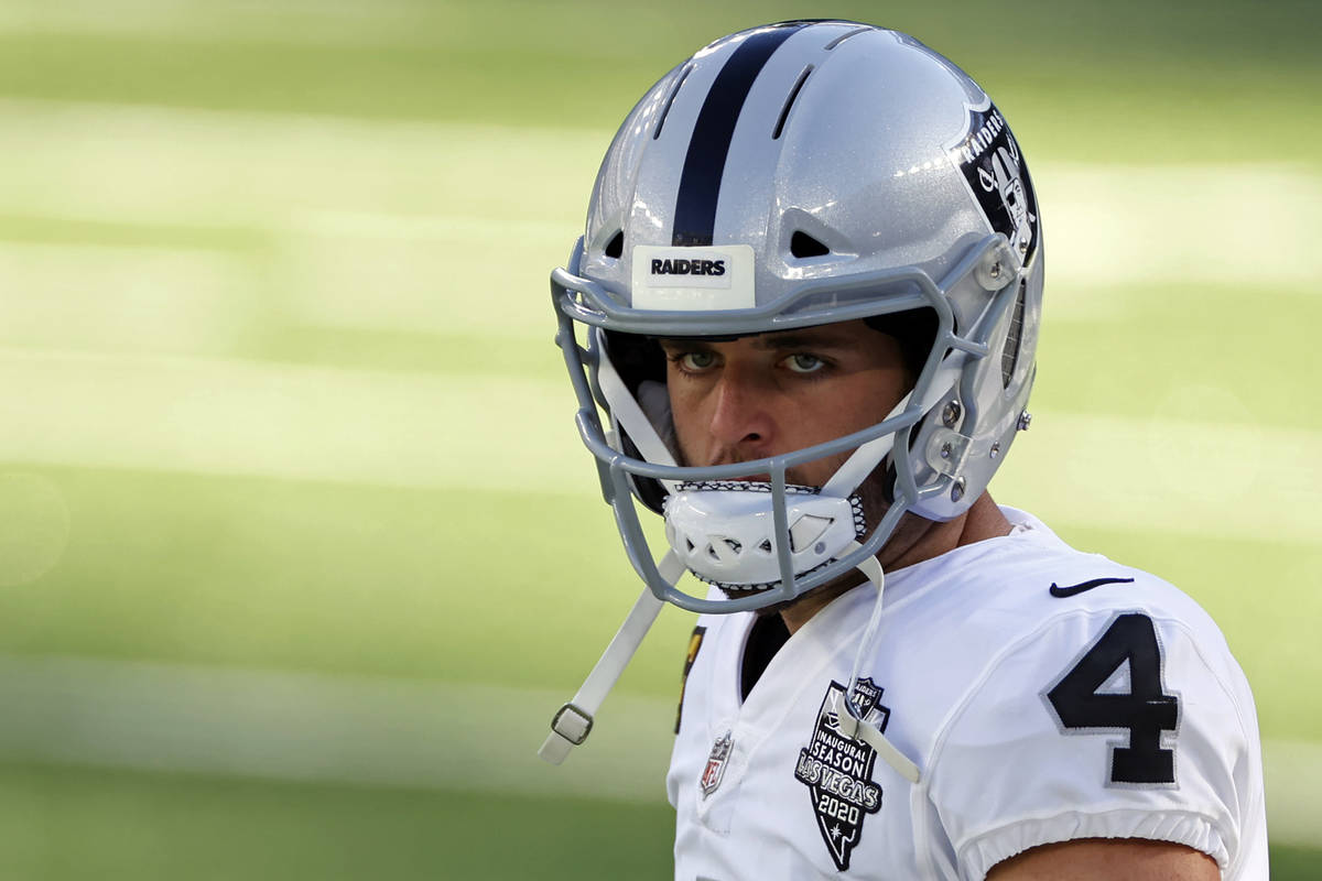 Las Vegas Raiders quarterback Derek Carr (4) looks on before an NFL football game against the N ...