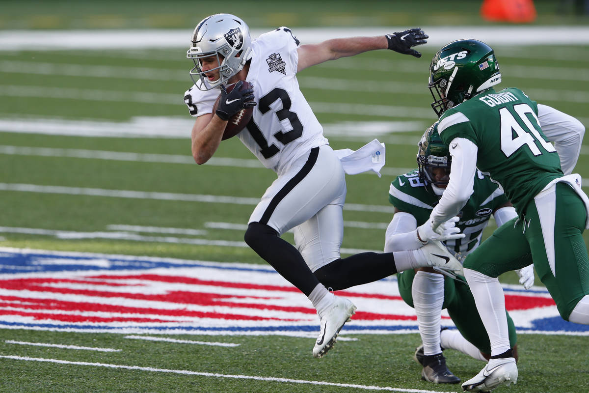 Las Vegas Raiders' Hunter Renfrow, left, tries to evade the New York Jets defense during the fi ...