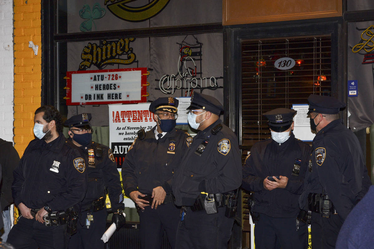 New York City sheriff's deputies stand outside Mac's Public House after co-owner Danny Presti w ...