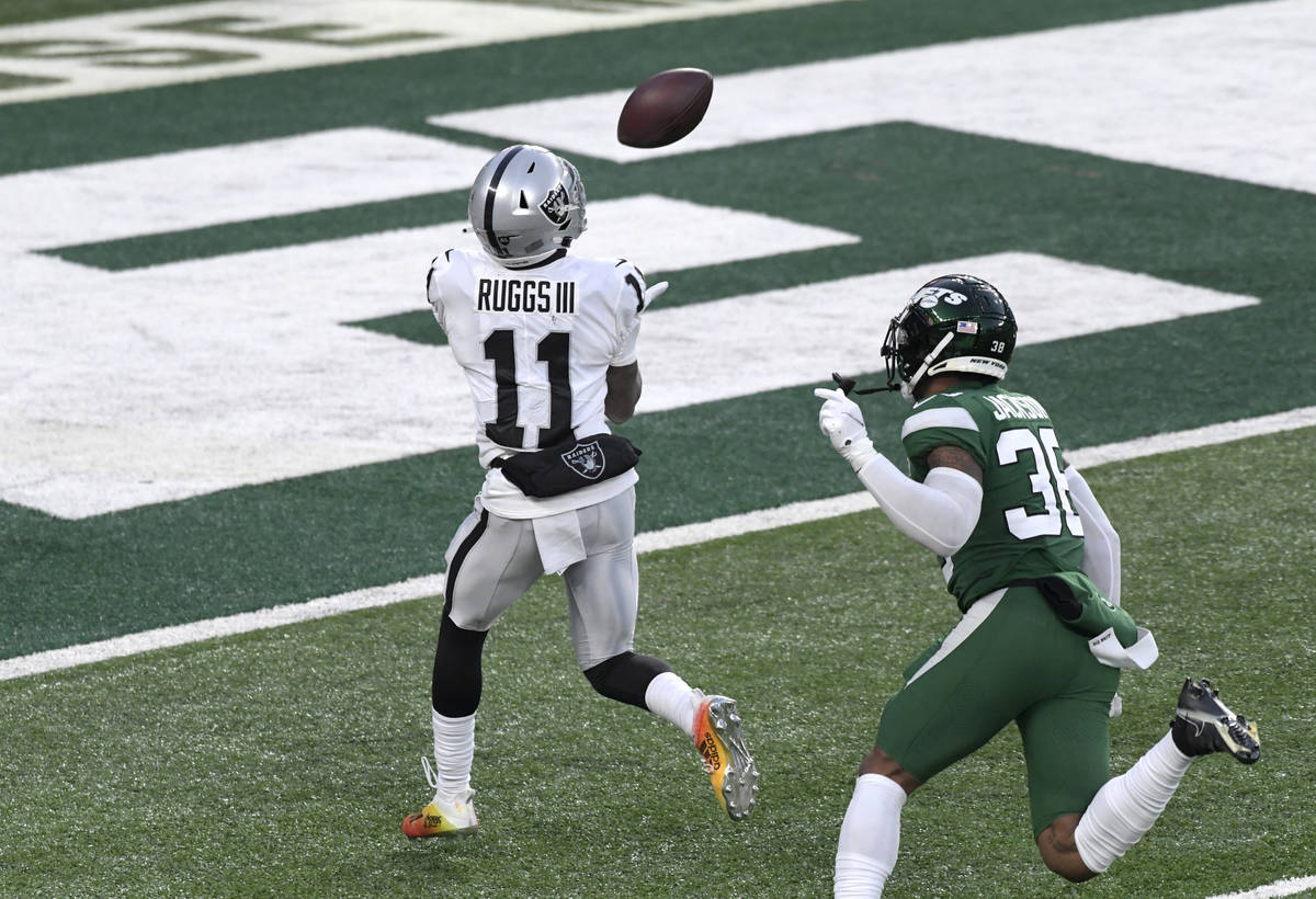 Las Vegas Raiders' Henry Ruggs III, left, catches a touchdown during the second half an NFL foo ...