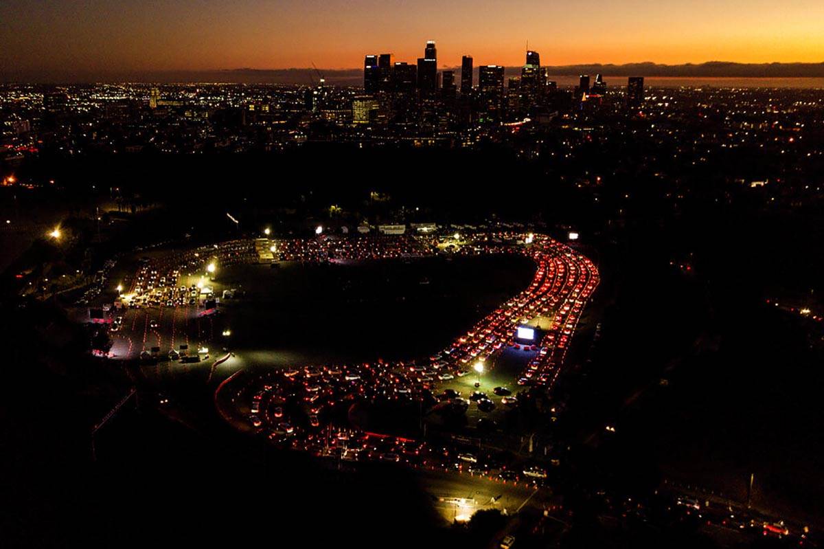In a Wednesday, Nov 18, 2020, file photo, motorists wait in long lines to take a coronavirus te ...