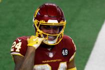 Washington Football Team running back Antonio Gibson (24) points to his mouth as he celebrates ...