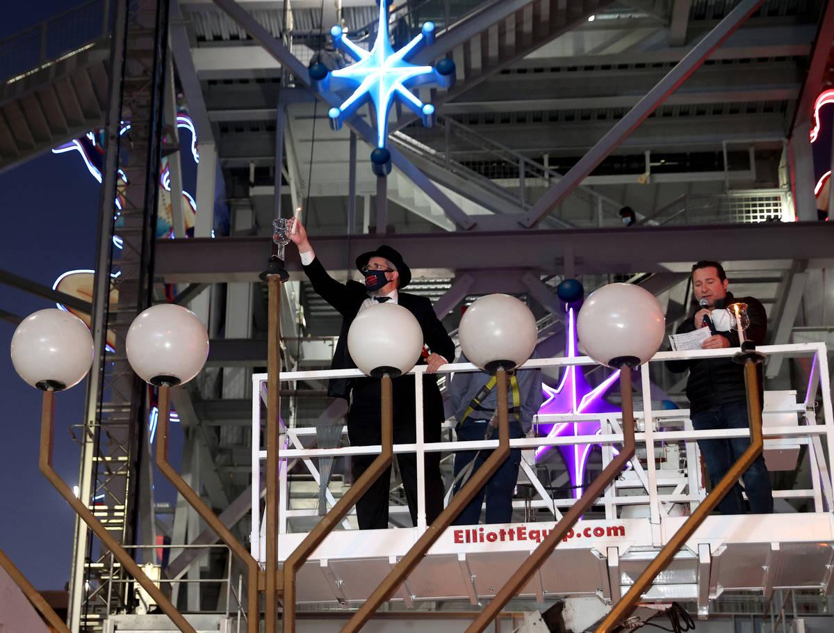 Rabbi Shea Harlig places the shamash candle, which is used to light the other candles, on the G ...