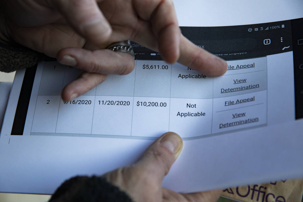 Thomas Elgas shows printed screenshots of his dealings with the Nevada Department of Employment ...
