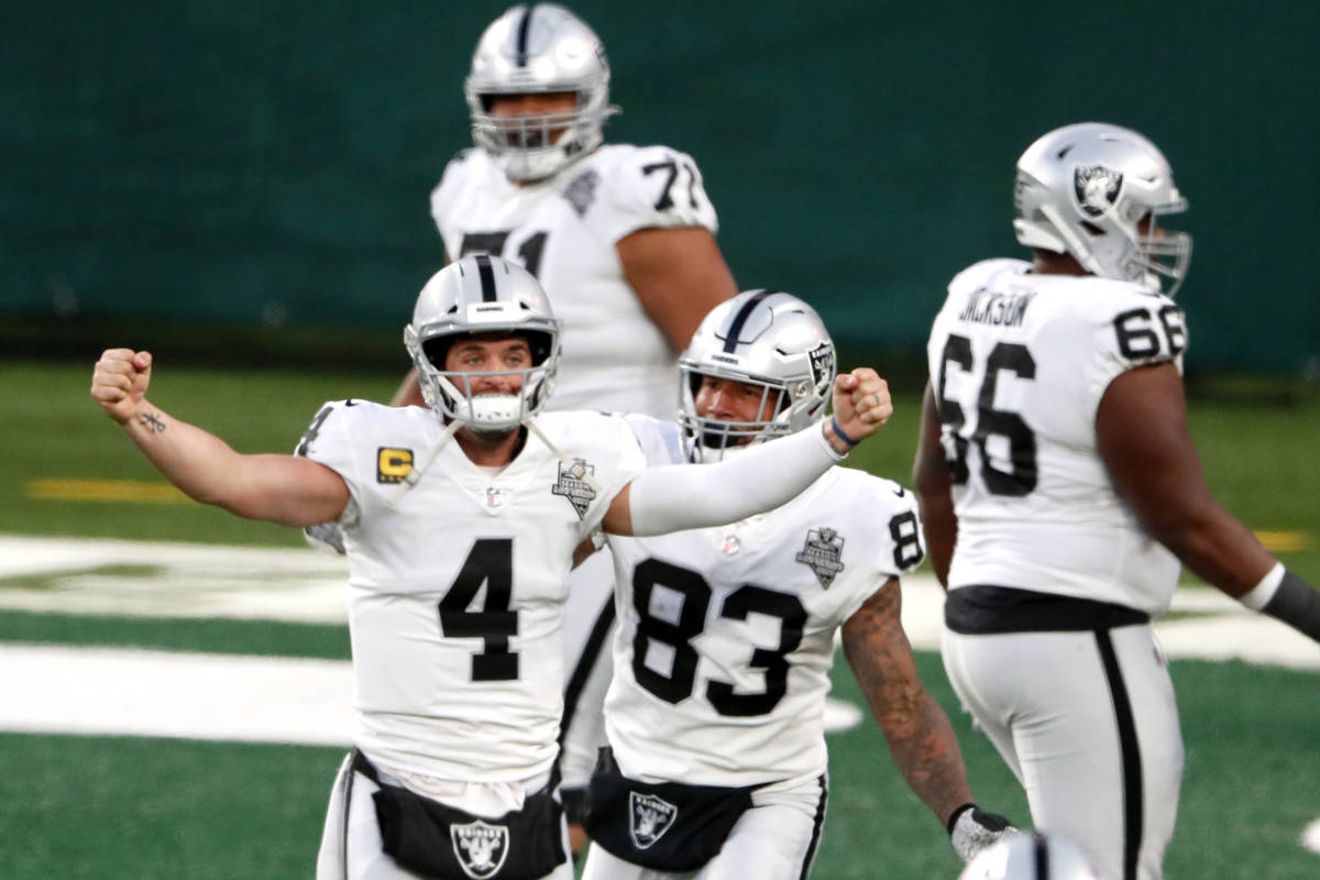 Las Vegas Raiders quarterback Derek Carr (4) celebrate after throwing a touchdown pass to Henry ...