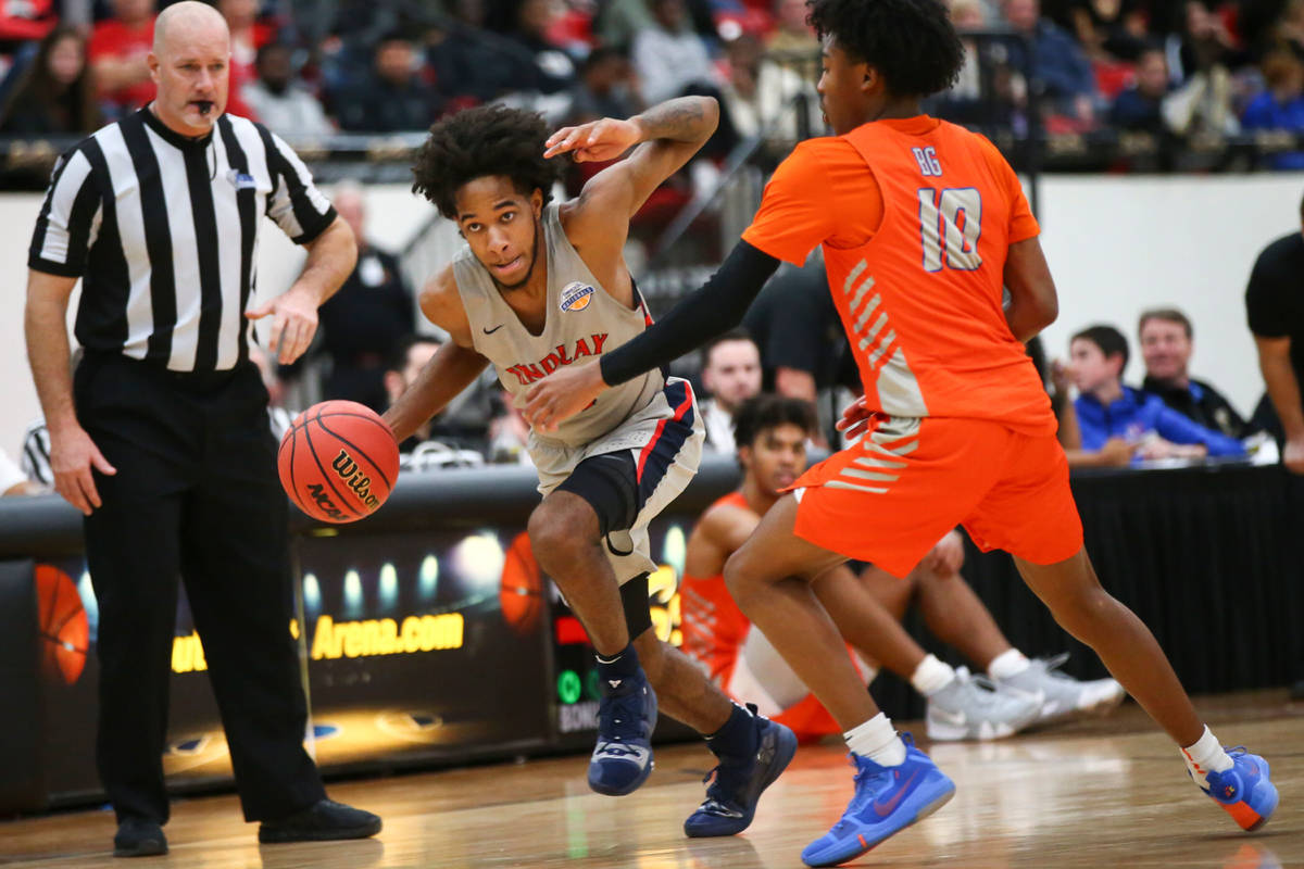 Findlay Prep's P.J. Fuller drives the ball against Bishop Gorman's Zaon Collins (10) during the ...