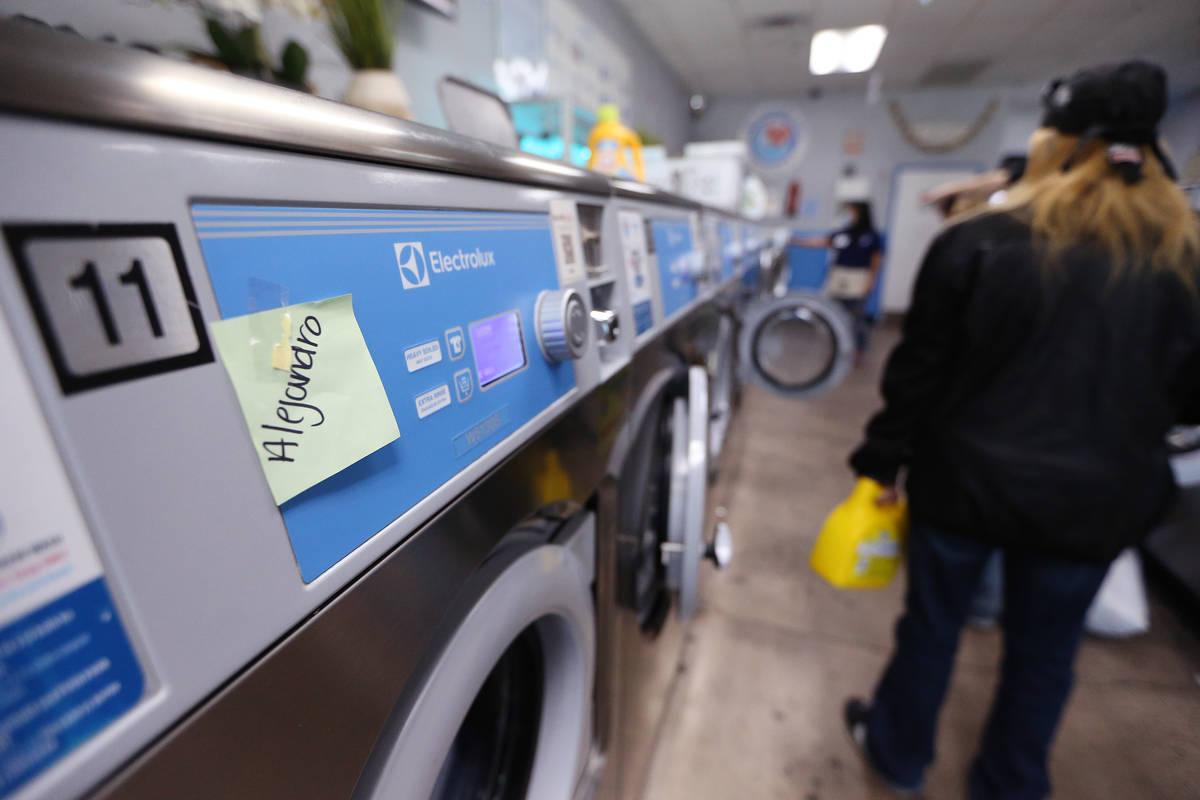 People do their laundry free of charge as part of the Laundry Project by Current Initiatives at ...
