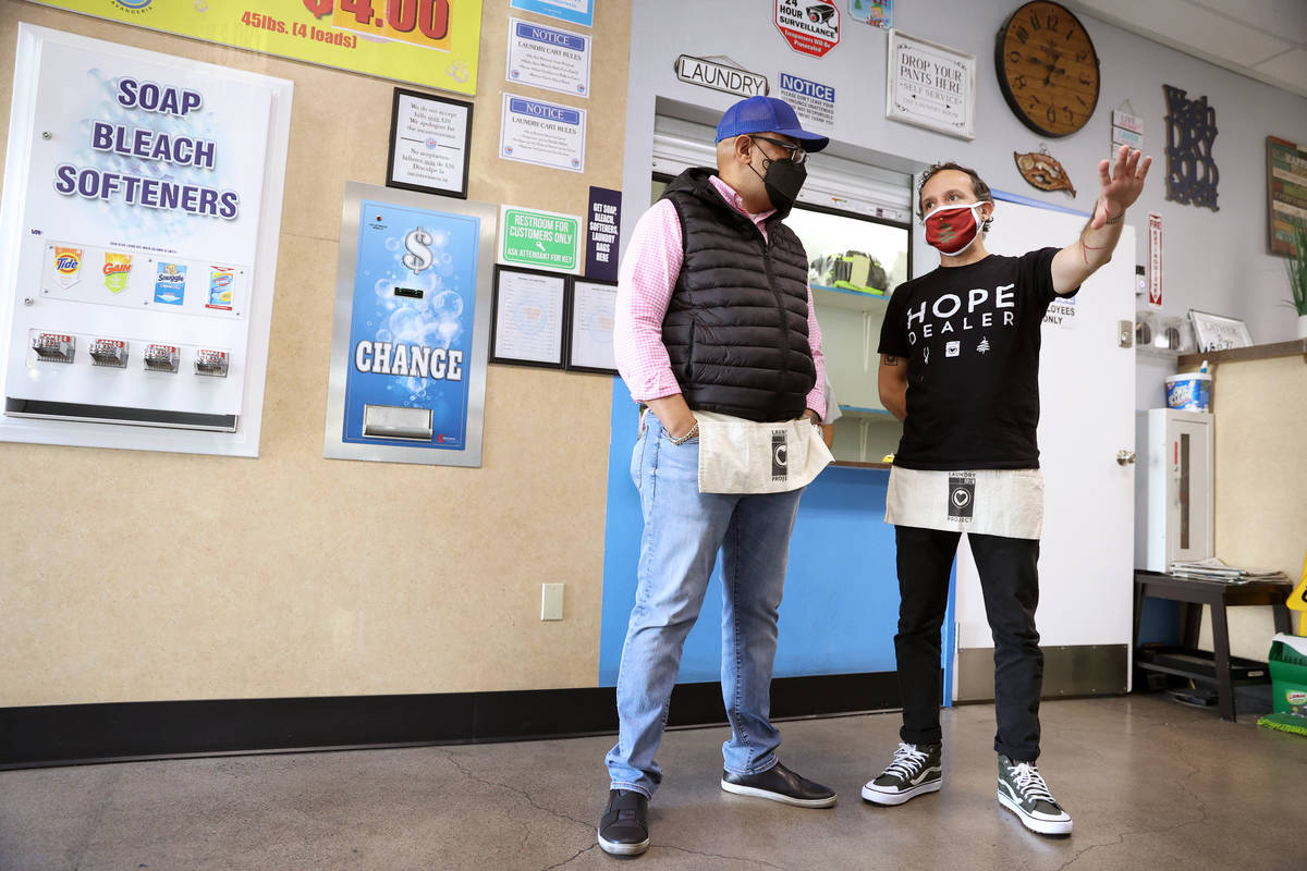 Adrian San Roman, left, owner of AJ’s Laundry Star, speaks with Jason Sowell, president ...