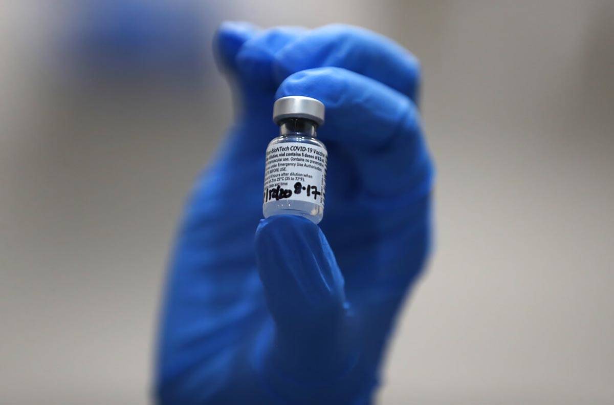 A nurse holds a phial of the Pfizer-BioNTech COVID-19 vaccine at Guy's Hospital in London, Tues ...